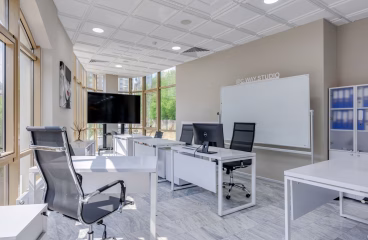 Spacious and bright modern office interior with sleek furniture, ideal for professional workspaces.
